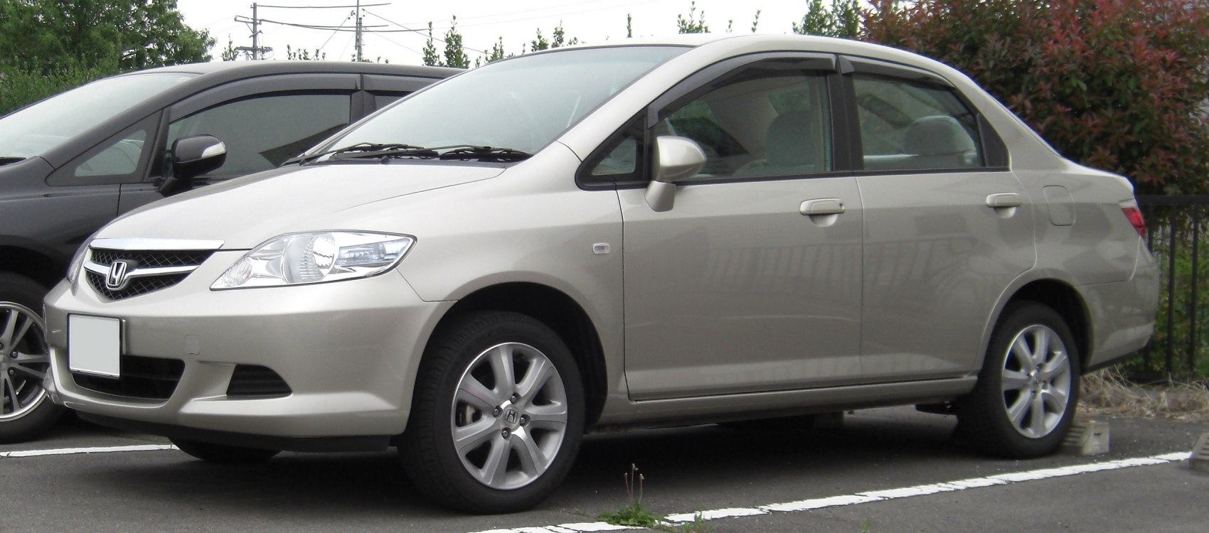 Sleek sedan side profile with chrome grille and alloy wheels