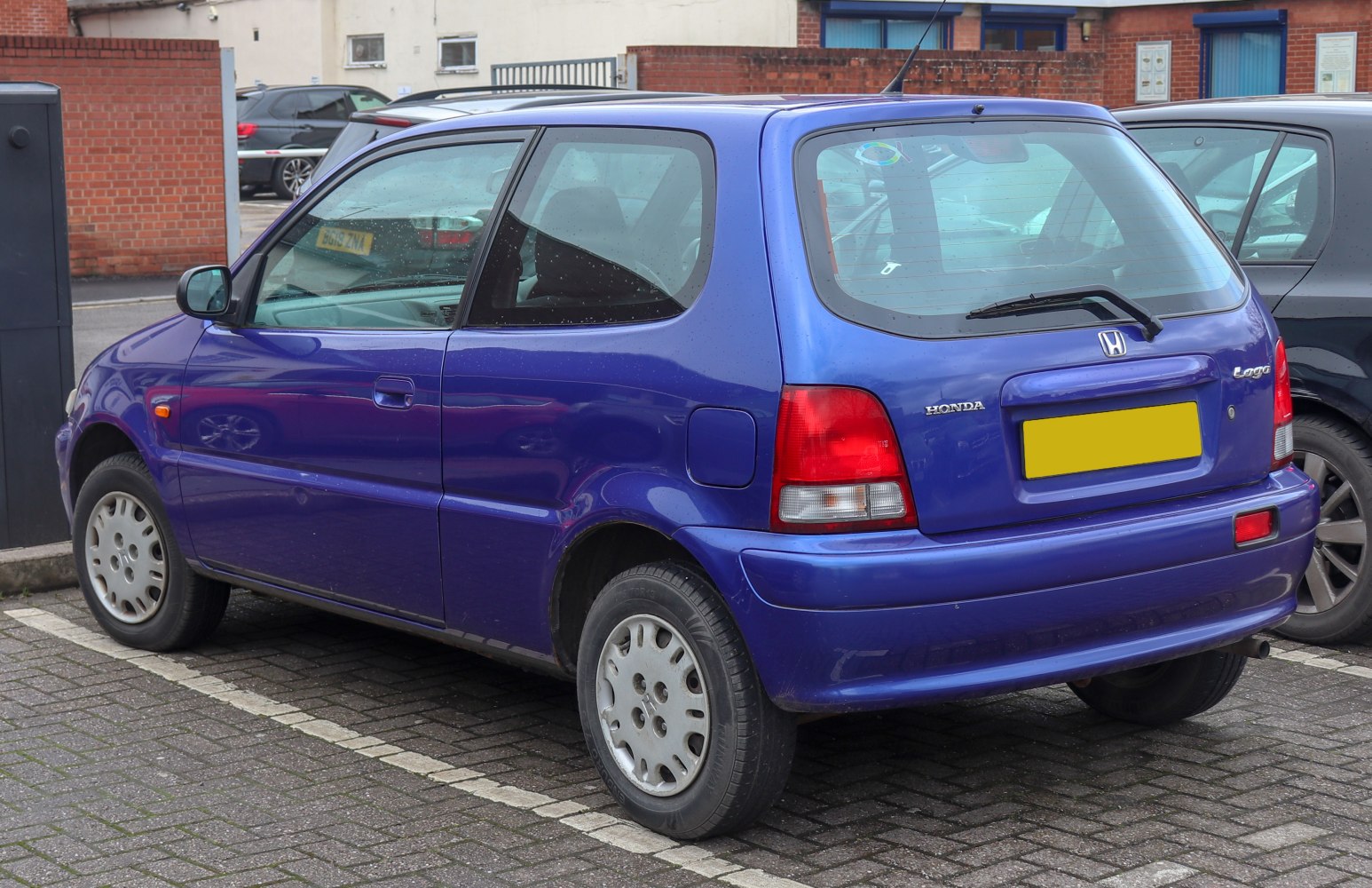 Rear and side view of compact hatchback with rear wiper and taillights