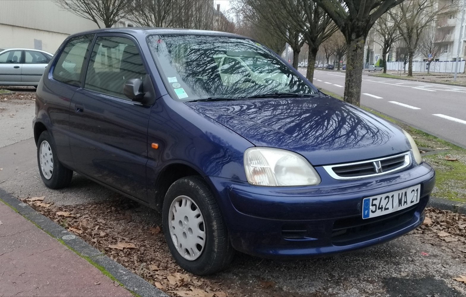 Front side view of a compact hatchback with rounded headlights