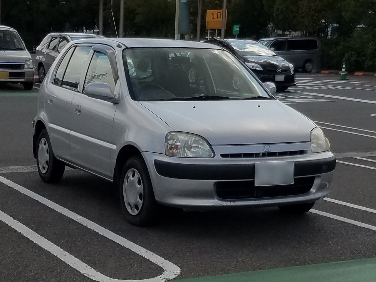Compact silver hatchback with rounded headlights and black bumper trim.