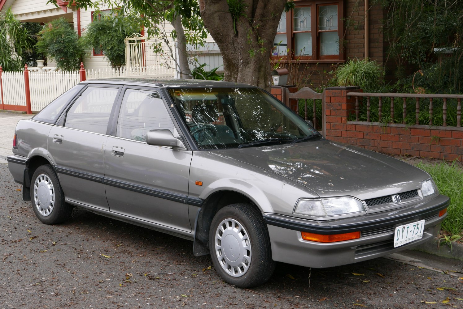Compact sedan with angular design and hubcap wheels.