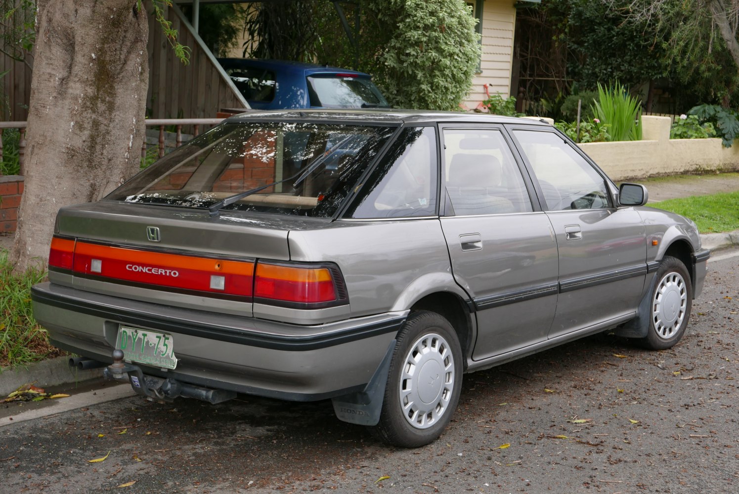 Rear and side view of a hatchback with wrap-around taillights and distinct wheel covers
