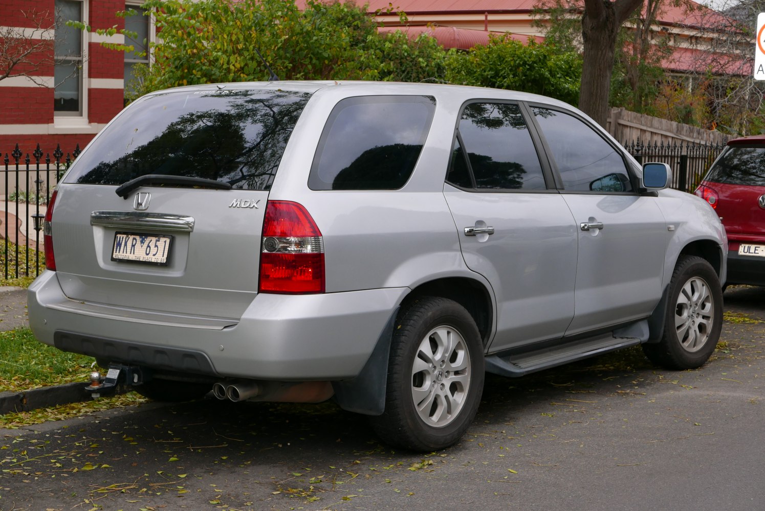 Silver SUV rear-side view with tinted windows and tow hitch