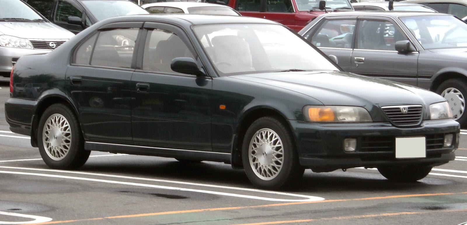 Classic mid-90s luxury sedan profile with alloy wheels and four-door design
