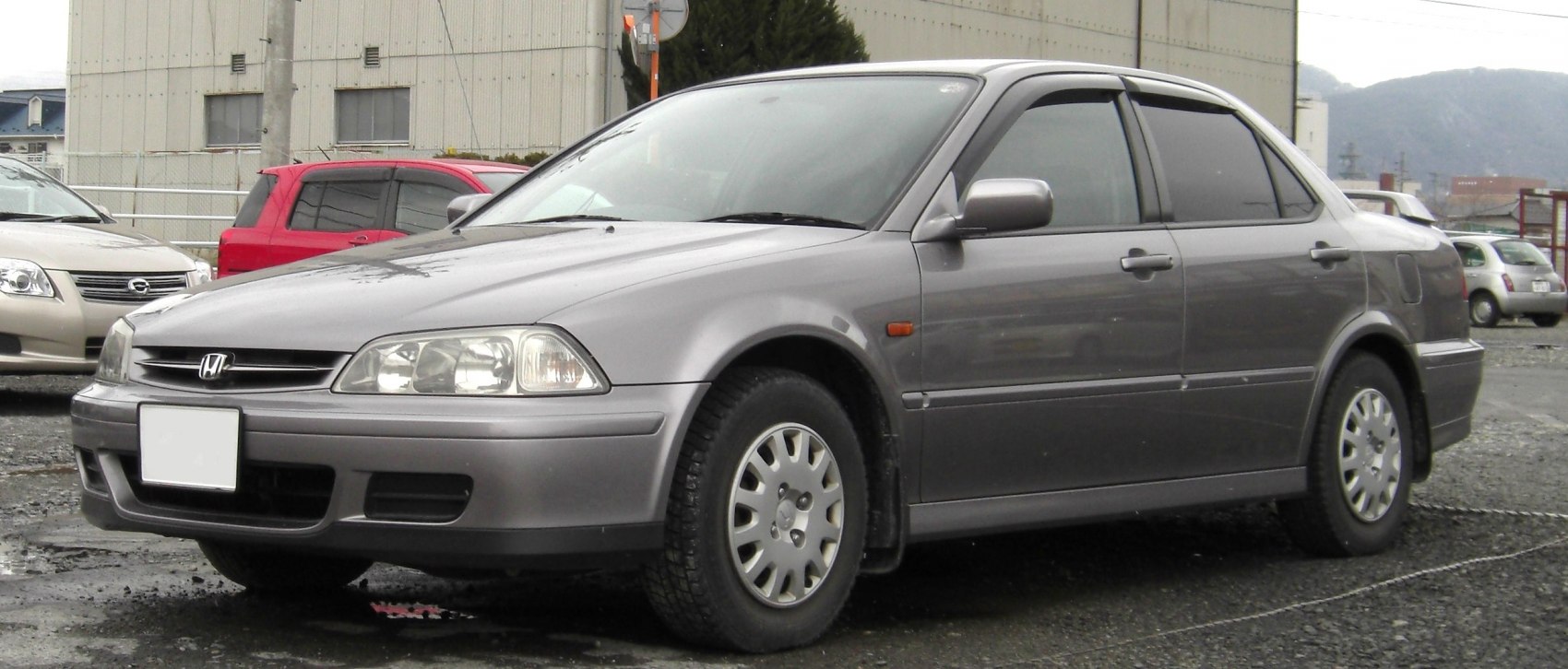 Sedan with multi-reflector headlights and alloy wheels