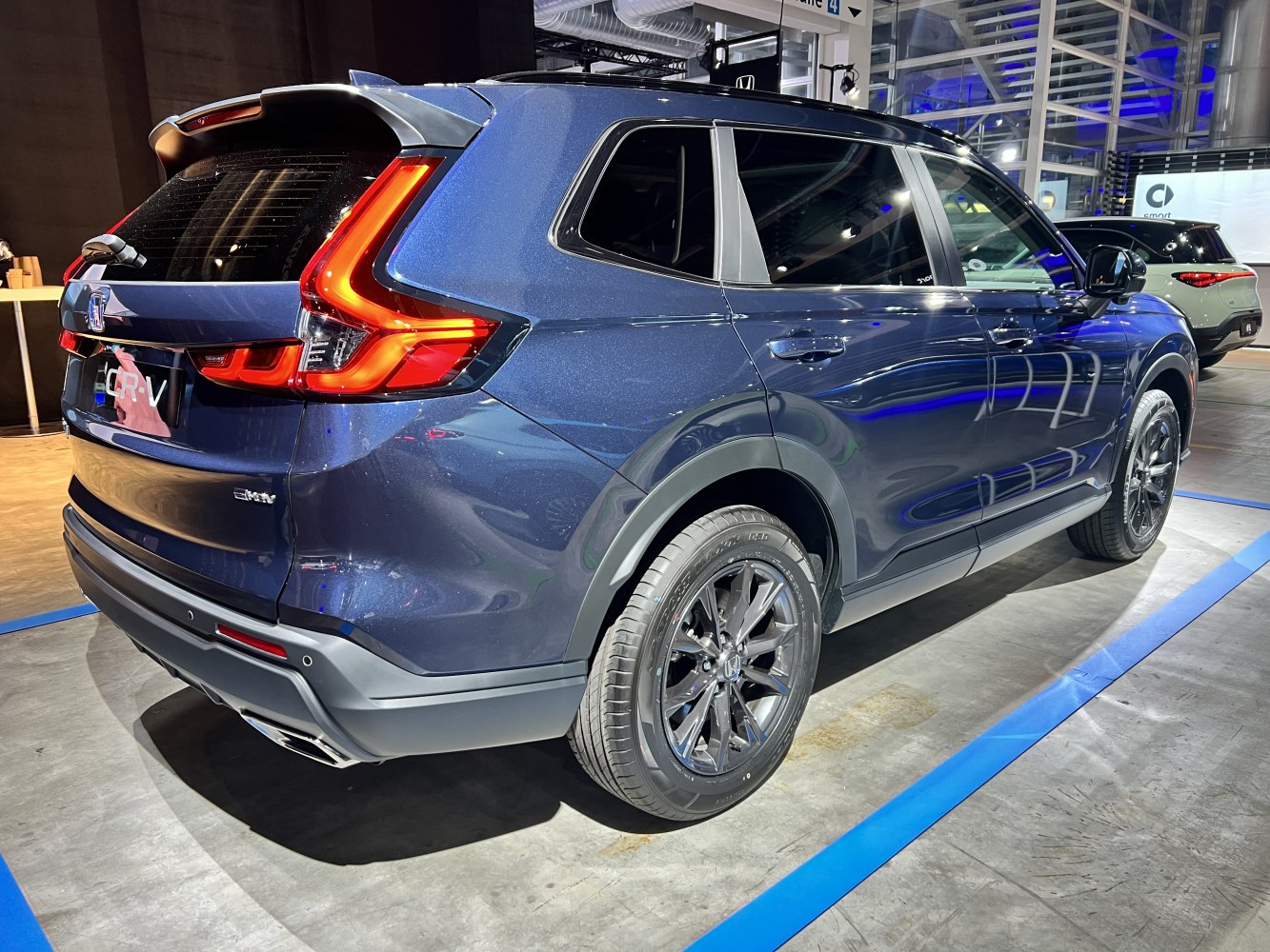 Rear and side view of SUV with prominent L-shaped LED tail lights and black alloy wheels