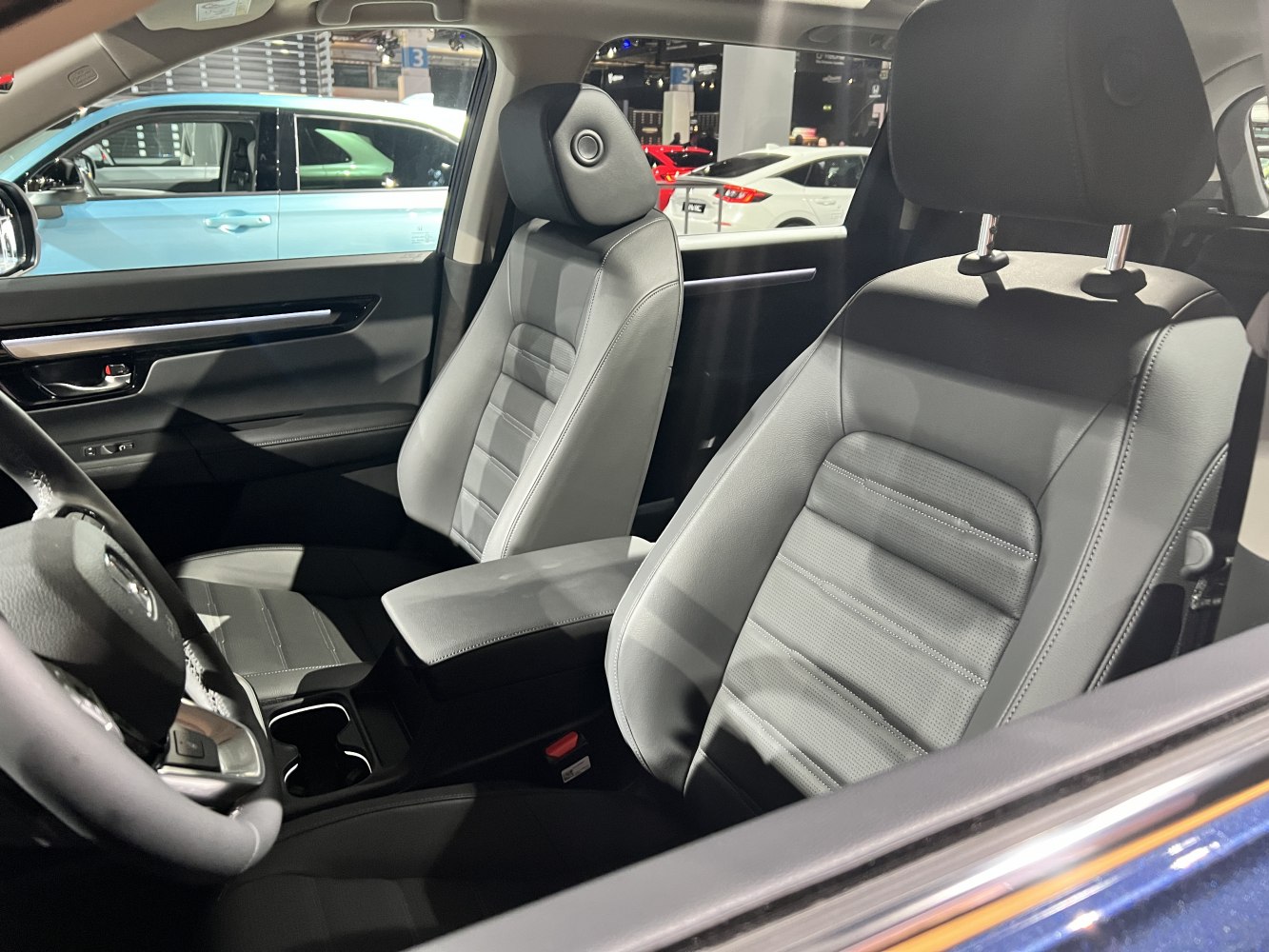 Leather front seats with adjustable headrests and center armrest