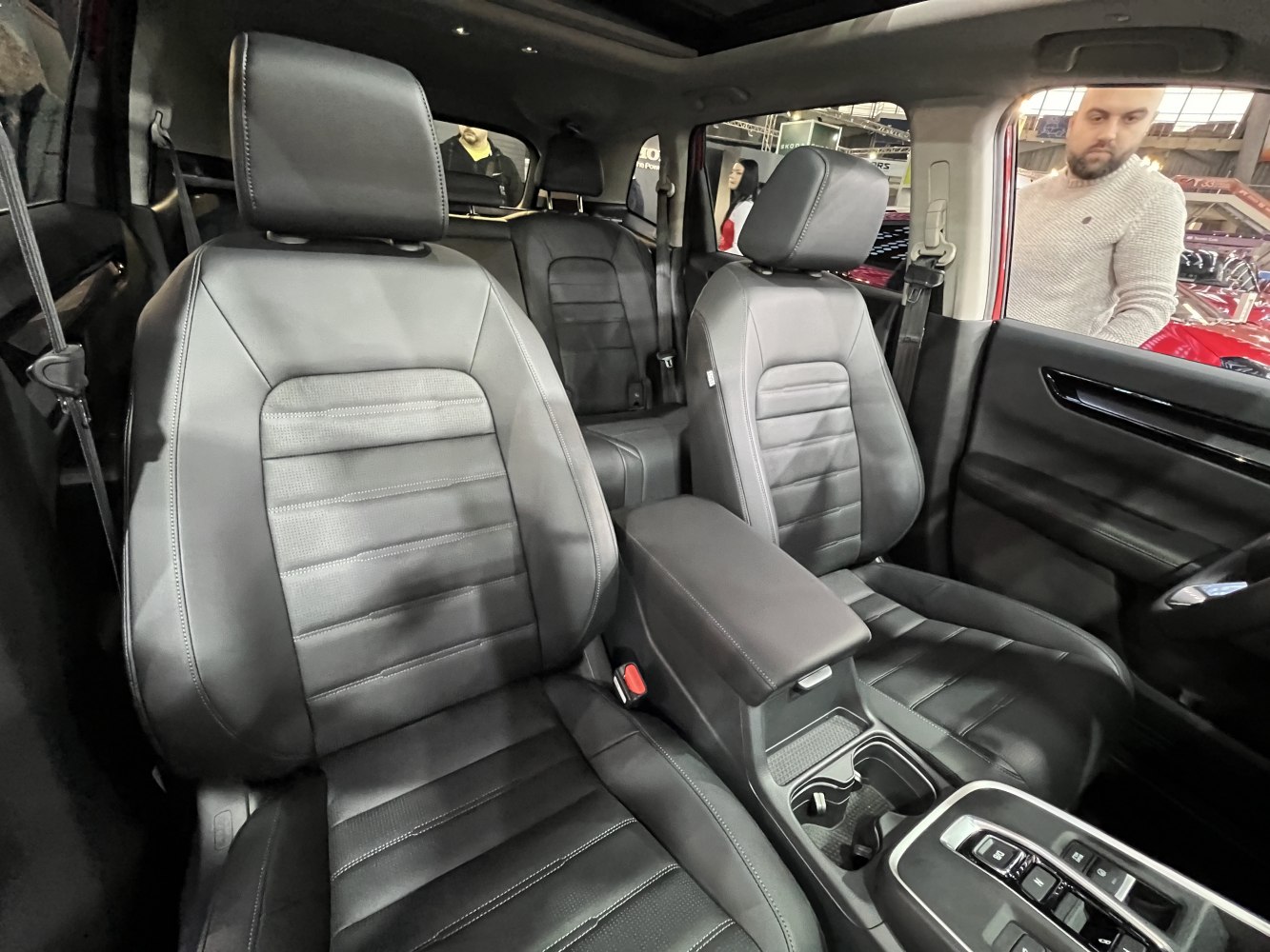 Leather front seats and center armrest console with cup holders