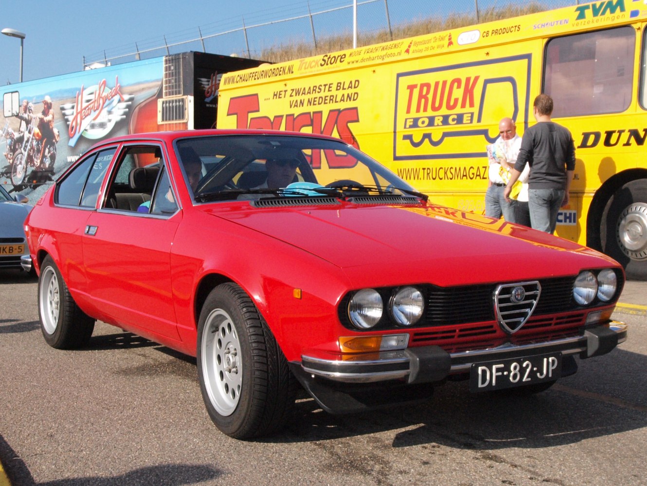 Red classic coupe with iconic front grille and round headlights