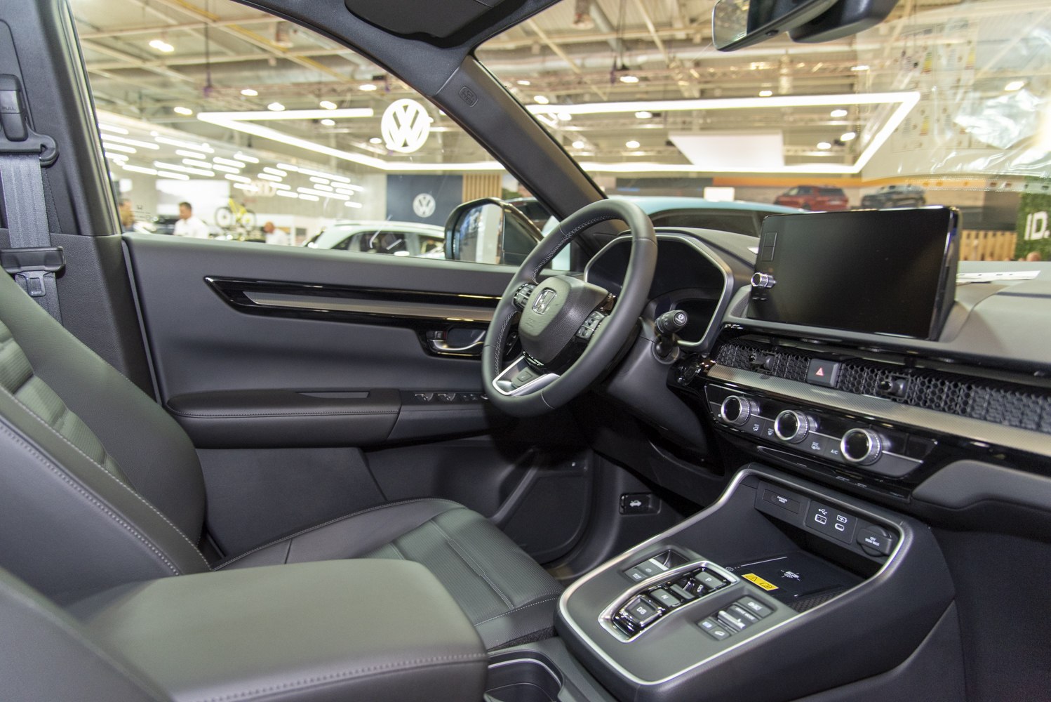 Modern car interior featuring digital display, ergonomic steering wheel, and climate controls