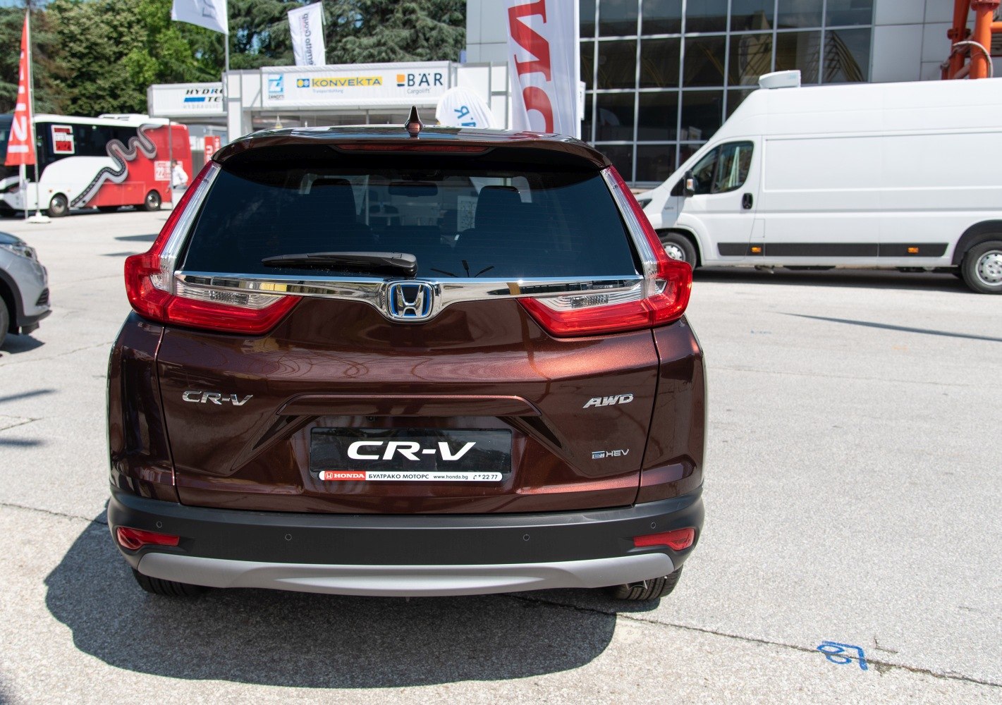 Rear view with AWD and hybrid badges and distinctive taillights