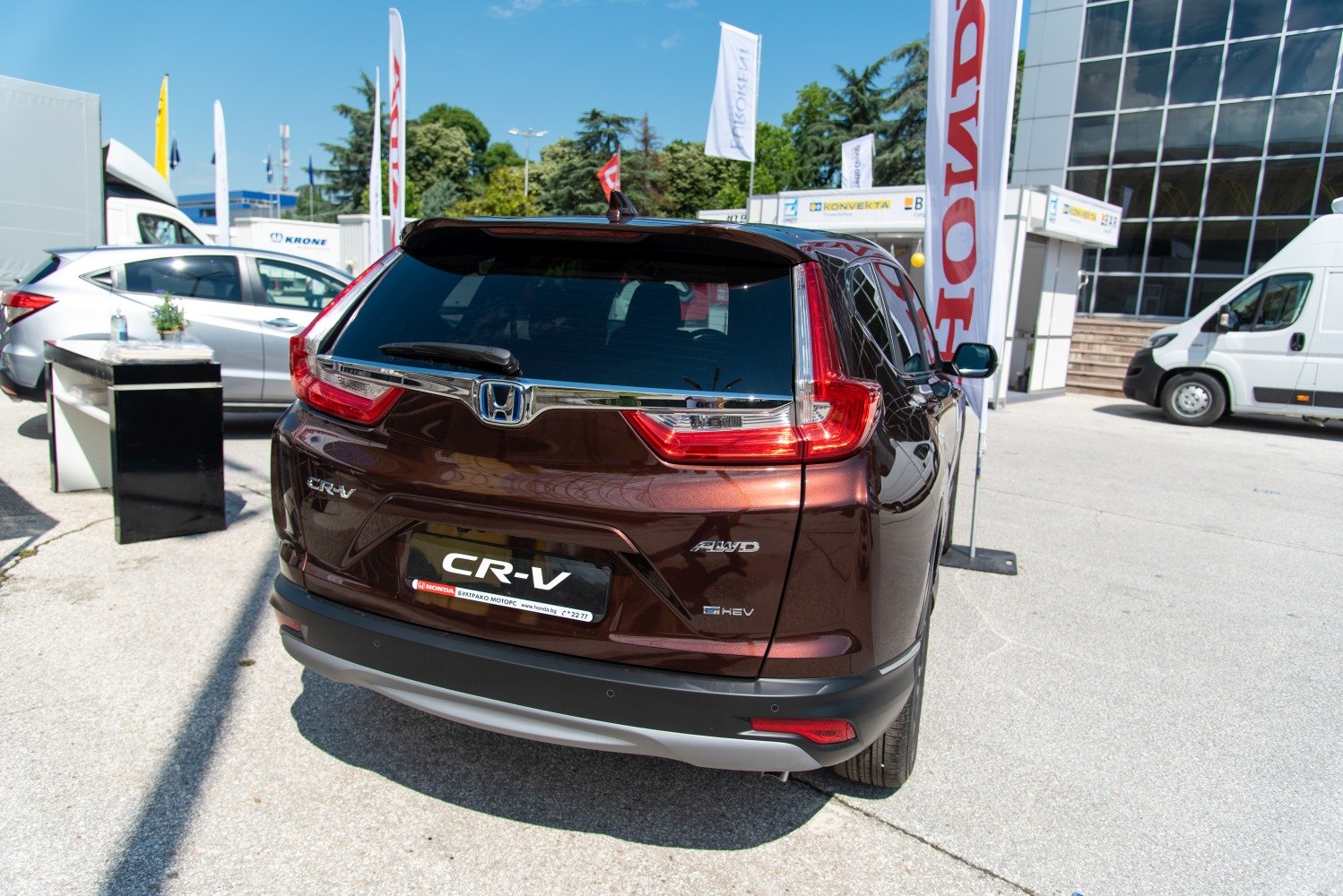 Rear view of SUV with distinctive tail lights, AWD and hybrid badges