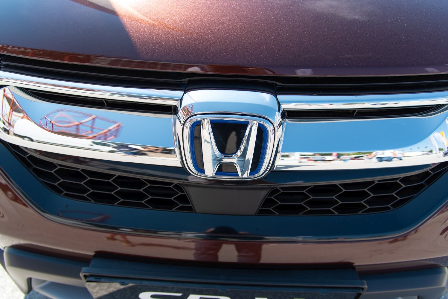 Close-up of glossy chrome front grille with honeycomb pattern