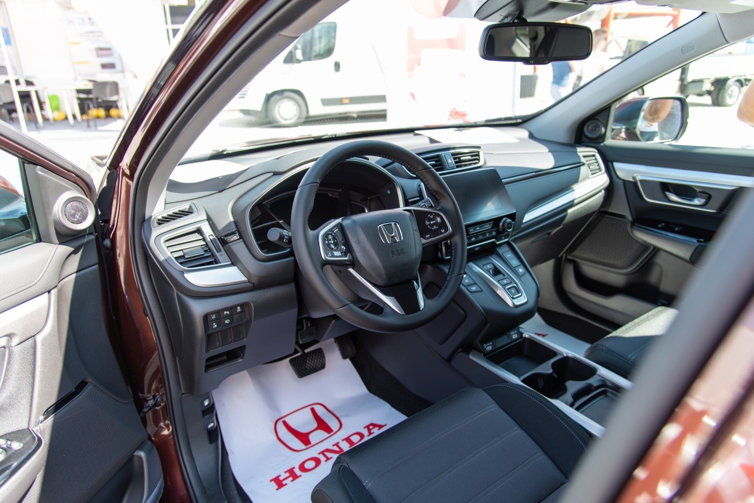 Modern SUV interior with multifunction steering wheel and advanced dashboard.