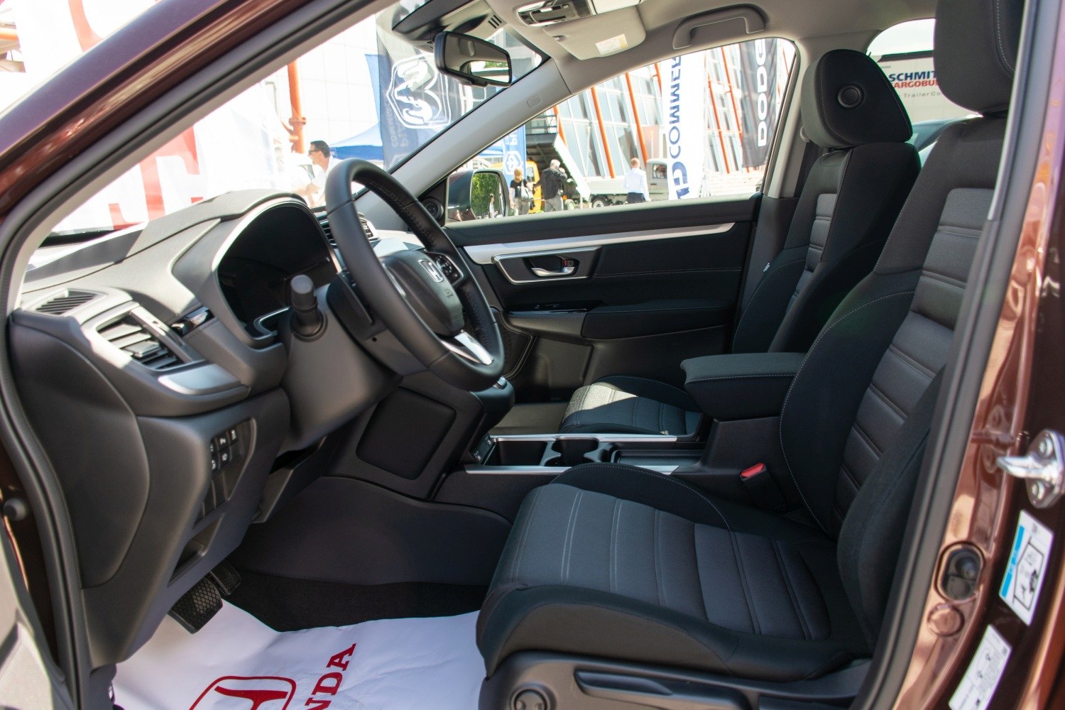Modern car interior with dashboard, steering wheel, and front seats