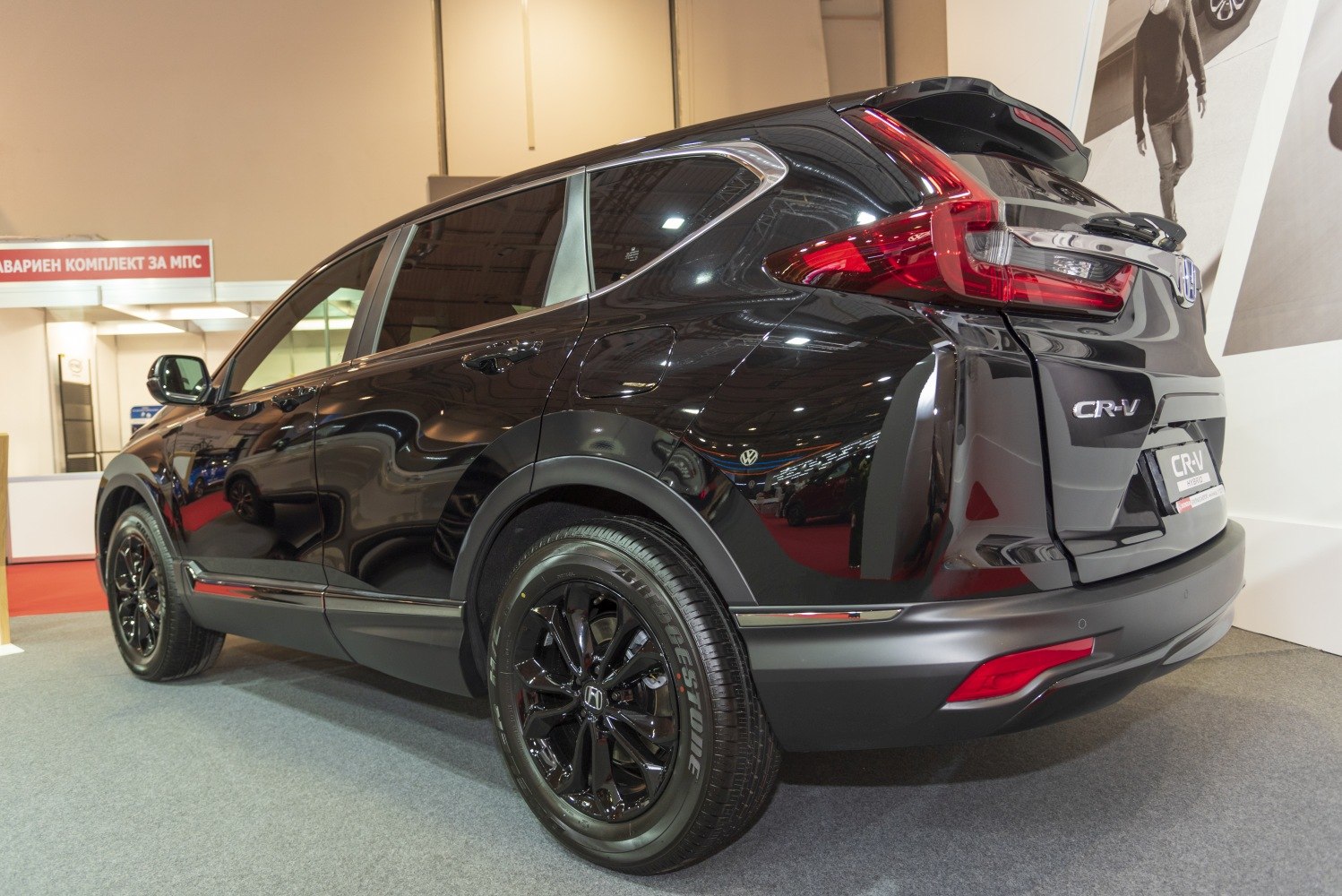 Rear side view with black alloy wheels and distinctive taillights