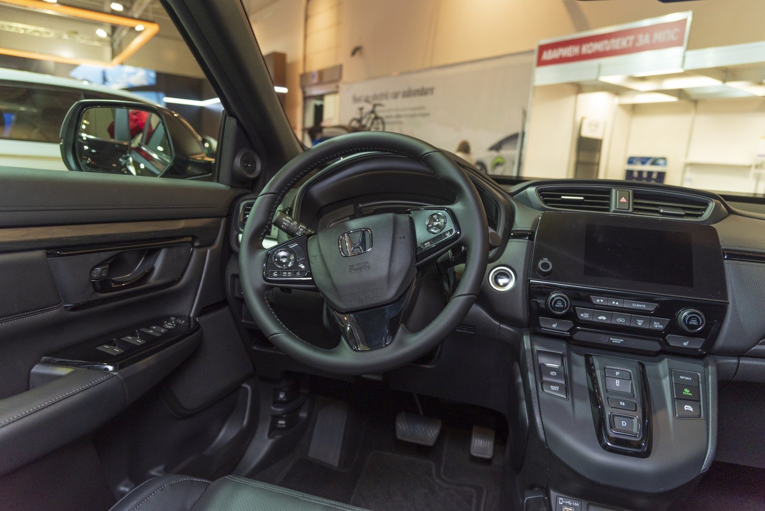 Modern car interior with dashboard, steering wheel, and control buttons