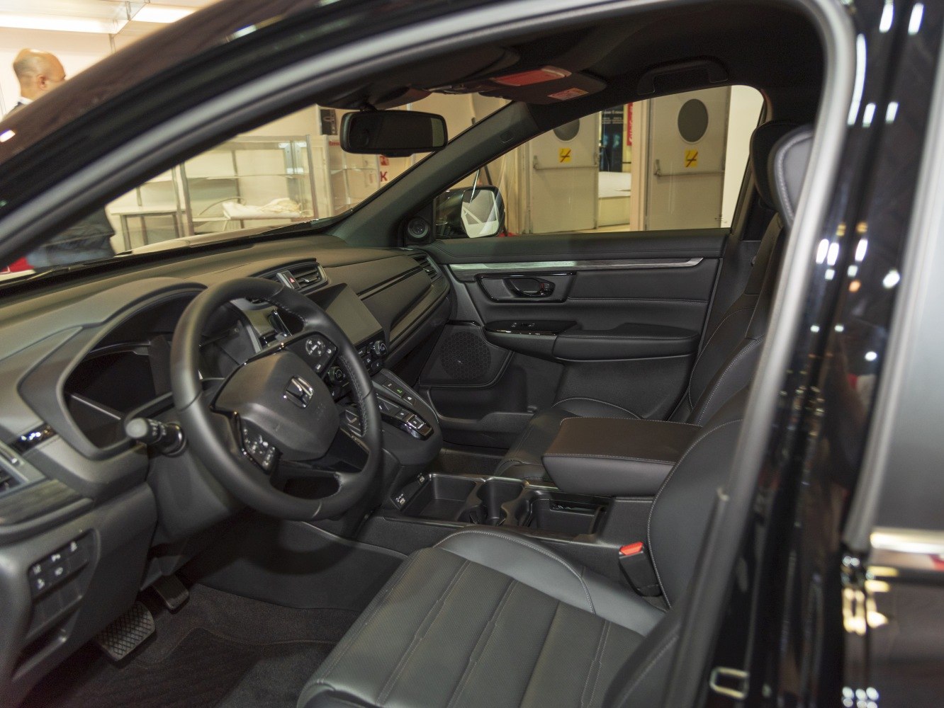 Spacious black leather seats, steering wheel, and dashboard with center console.