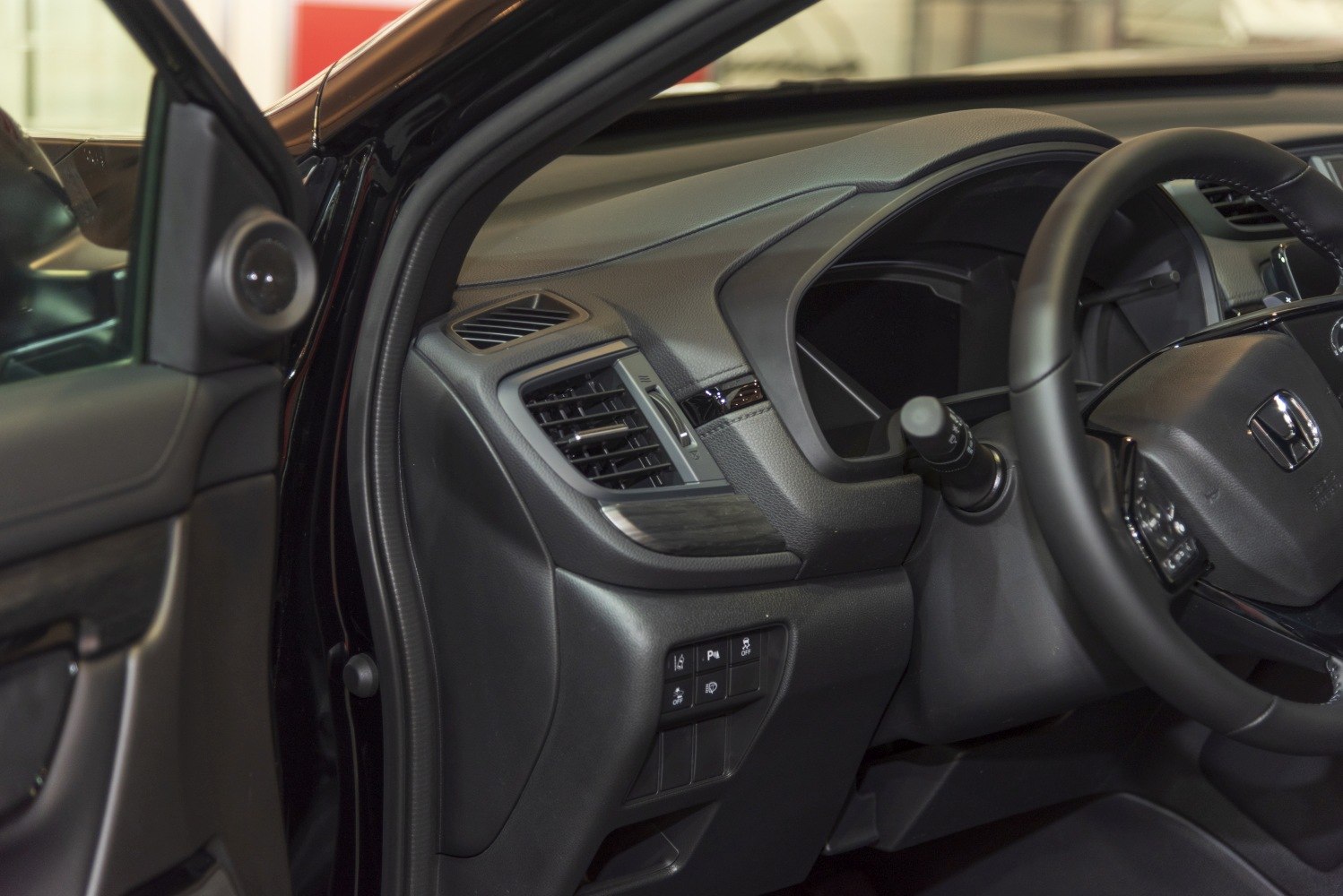 Close-up of dashboard, steering wheel, and control buttons