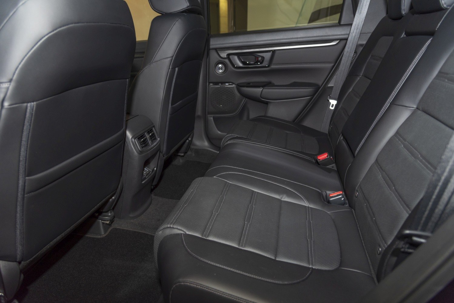 Rear seat interior with black leather upholstery and rear air vents