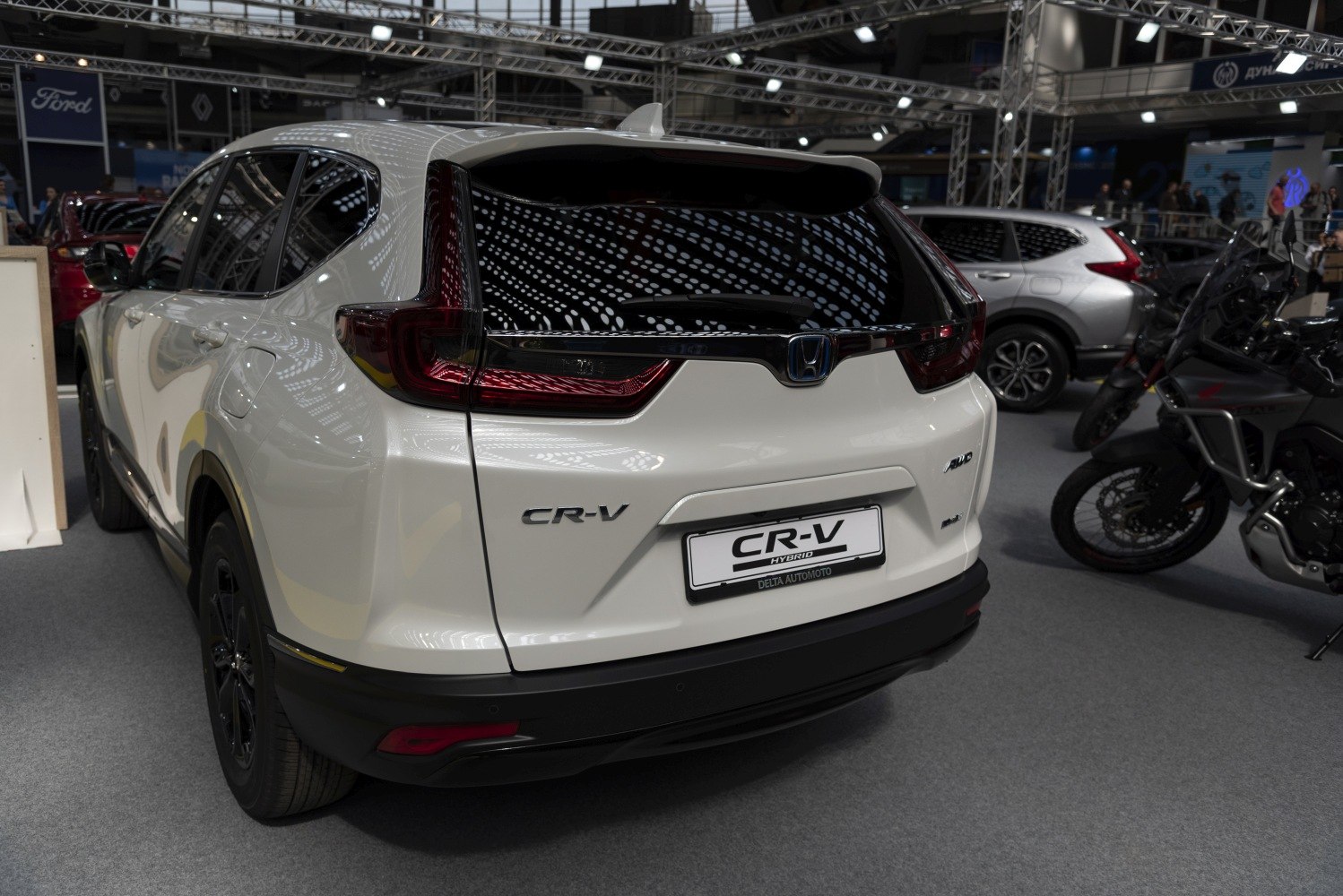 Rear view of an SUV with distinctive taillights and hybrid badge