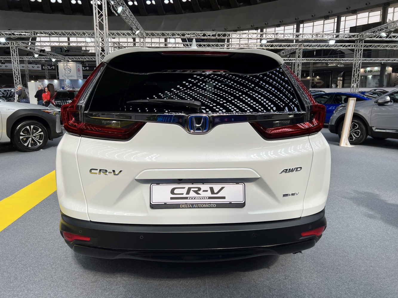 Rear view with hybrid and AWD badging, distinctive tail lights
