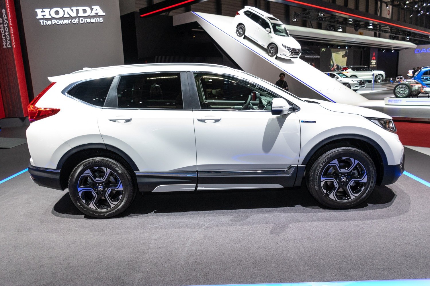 Side profile of white mid-sized SUV with distinctive alloy wheels