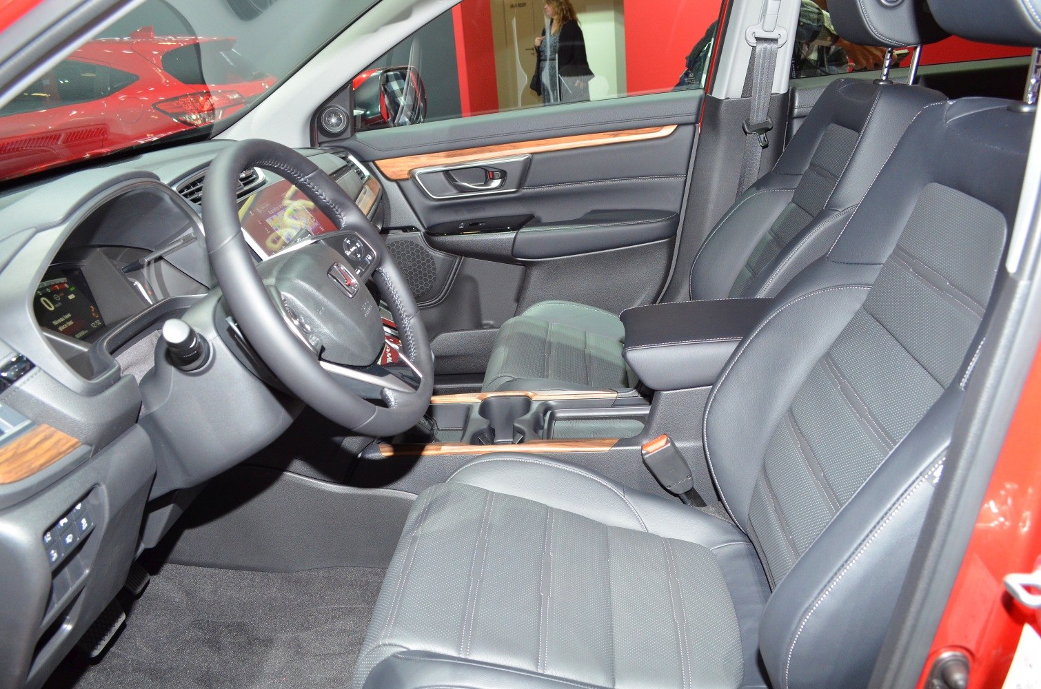 Luxury car interior with black leather seats and wood trim