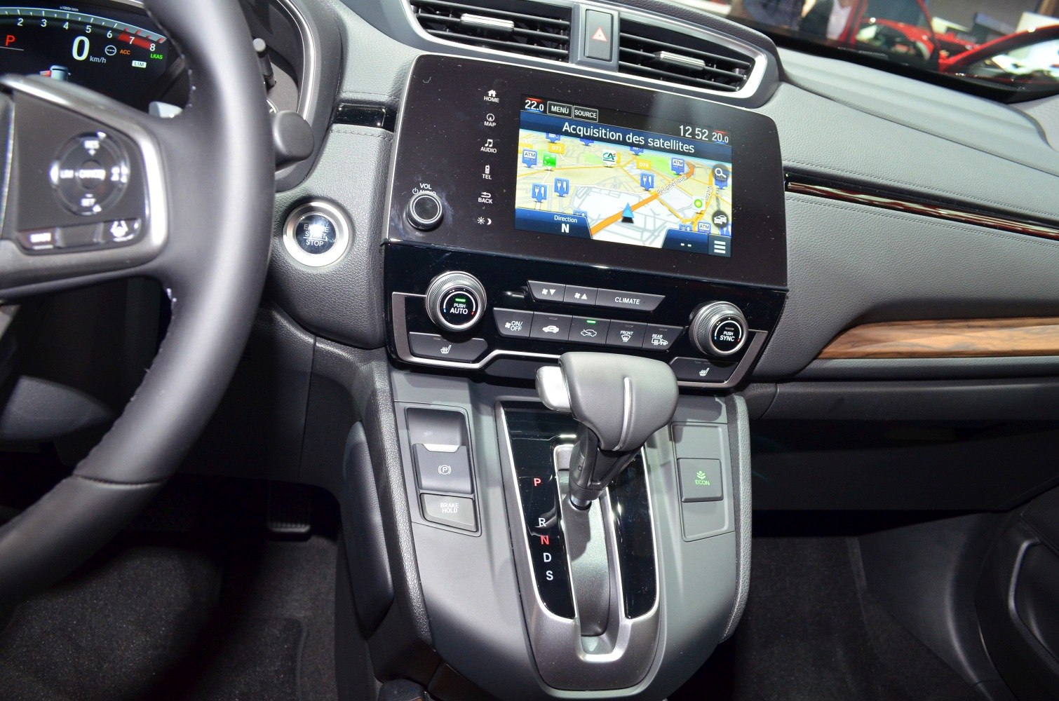 Automatic gear shifter and touchscreen navigation system in vehicle center console