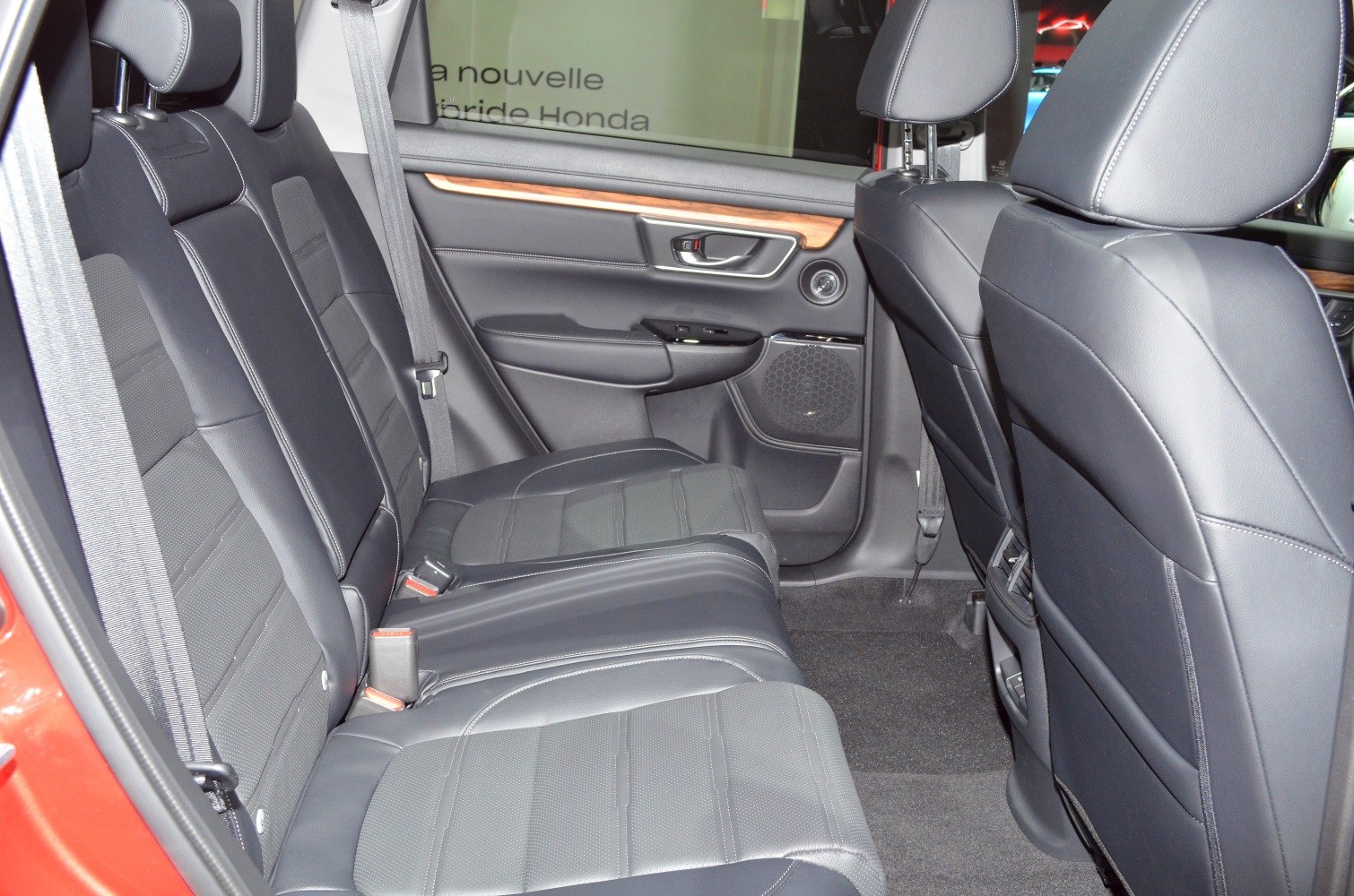 Black leather rear seats with door panel wood trim and seat belts