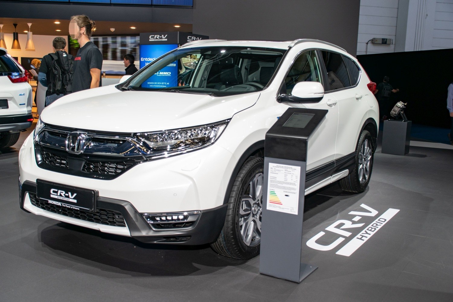 White SUV with LED headlights and alloy wheels displayed indoors