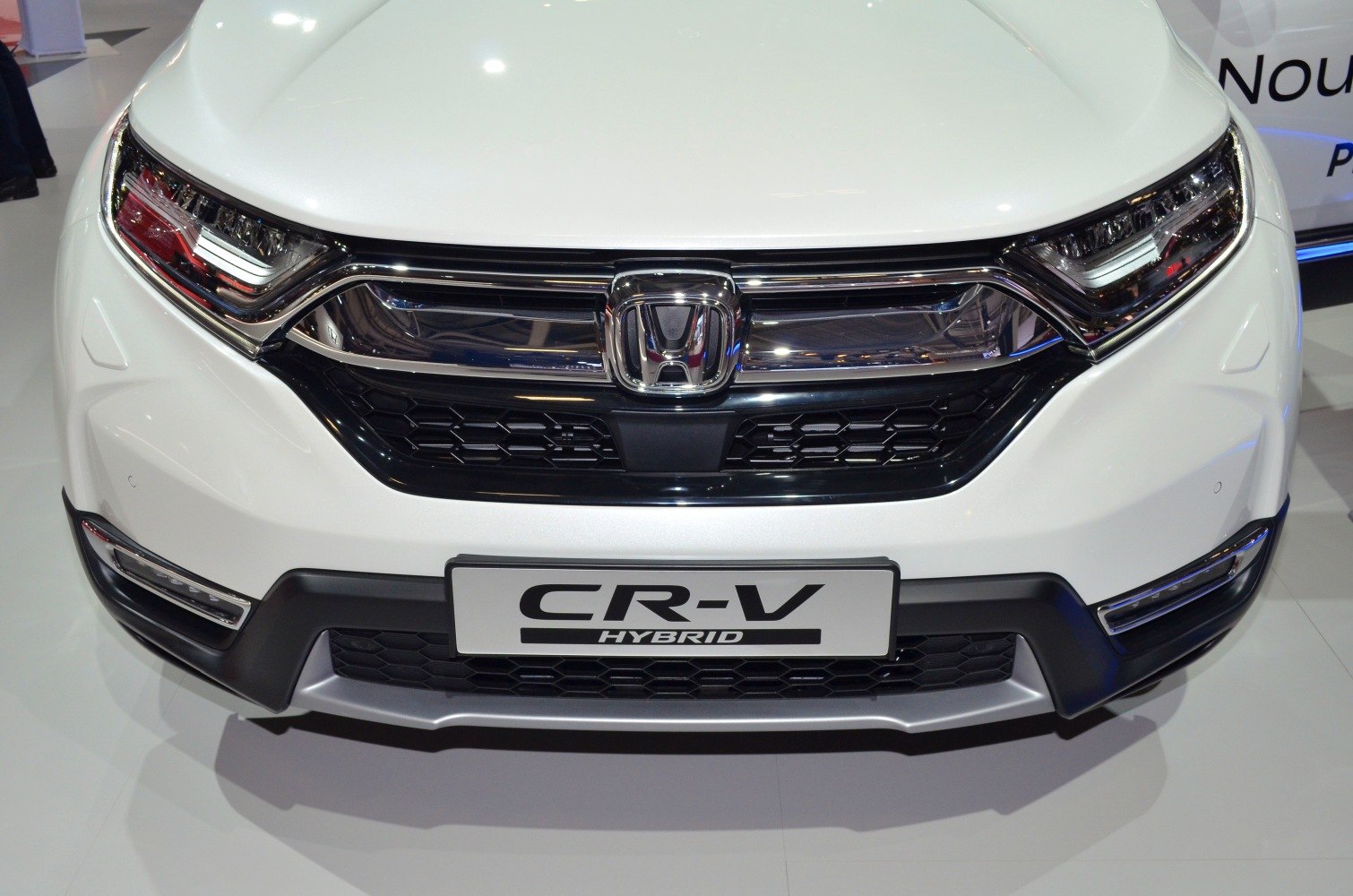 Front grille and LED headlights of a white SUV