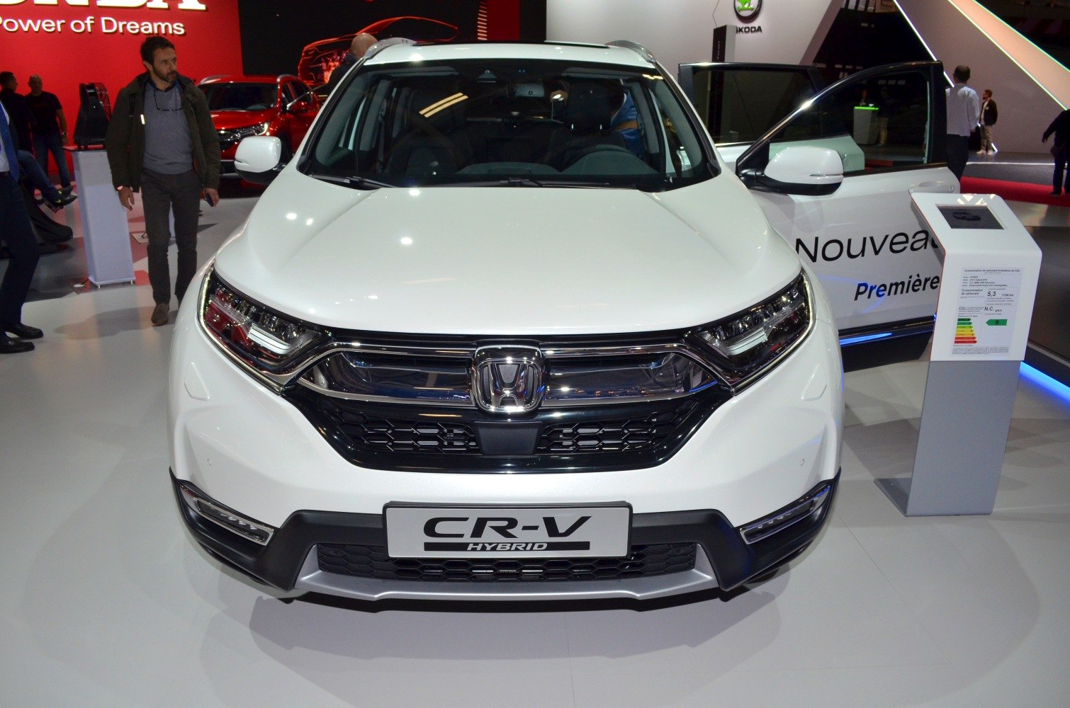 Front view with LED headlights and hybrid badge on white SUV