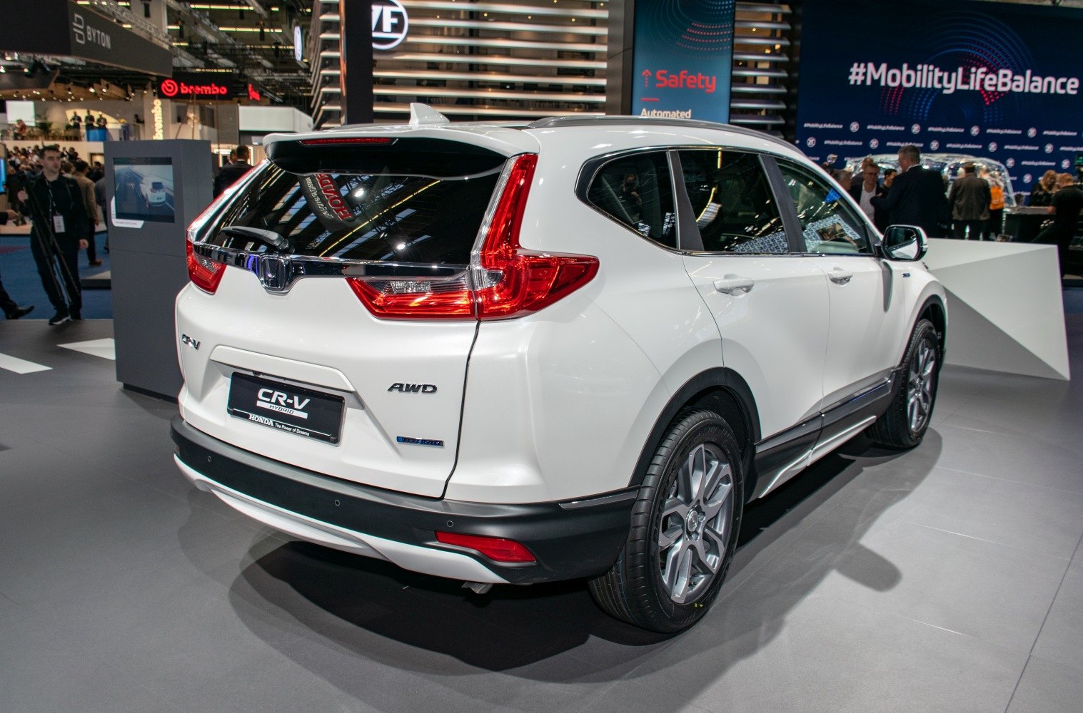 Rear view with distinct tail lights and AWD hybrid badge