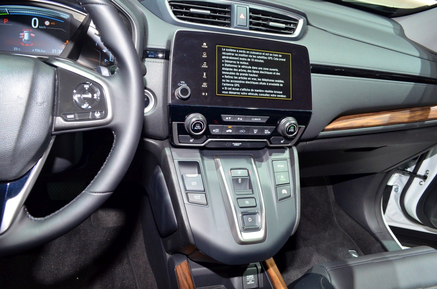 Modern dashboard and center console with digital display and gear selector buttons