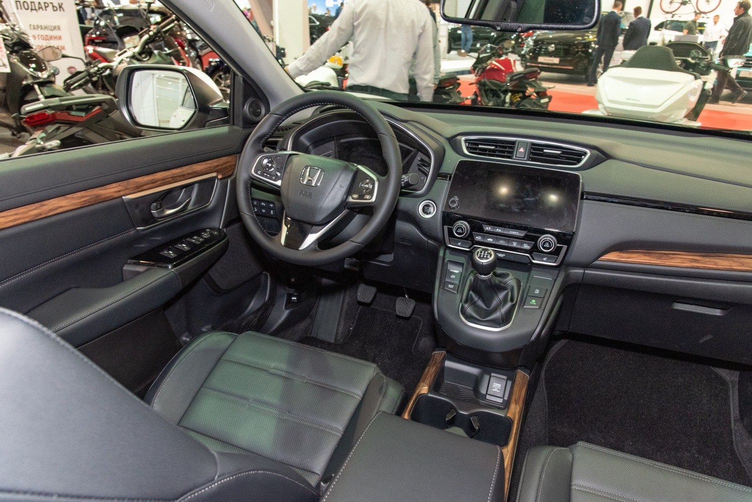 Dashboard, steering wheel, touchscreen, manual gear shift, wood trim