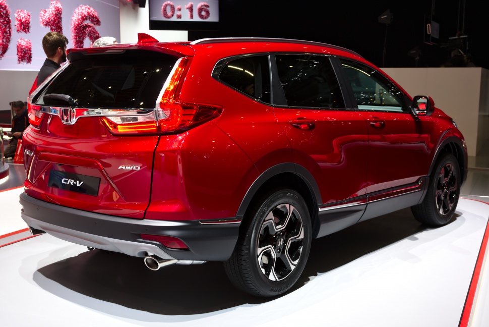Red SUV rear view with distinctive tail lights and alloy wheels