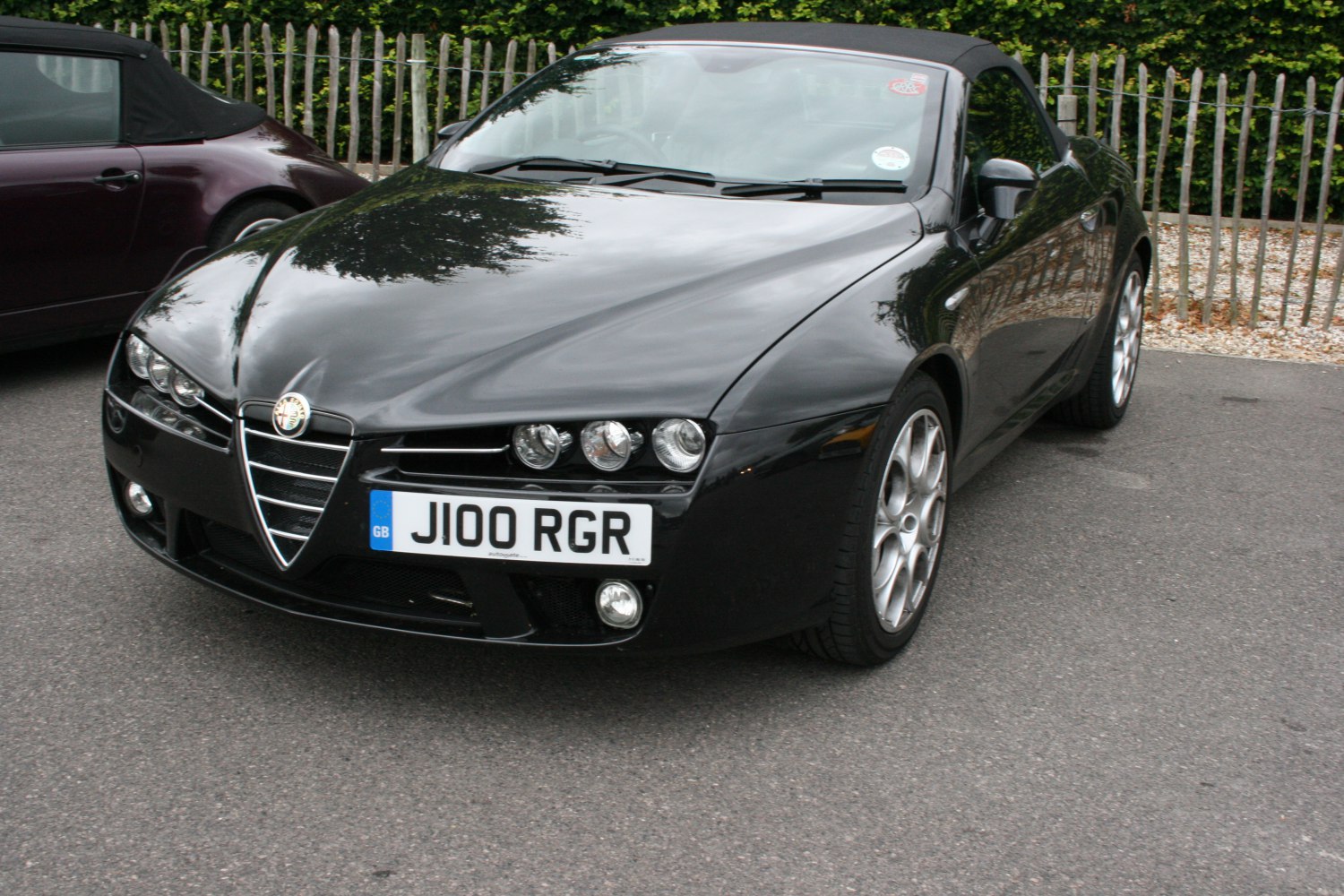 Front view of convertible with triangular grille and triple round headlights