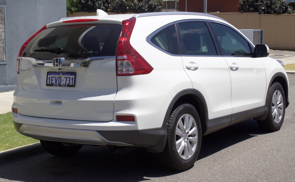 Rear and side profile of white SUV with distinctive taillights and body contours