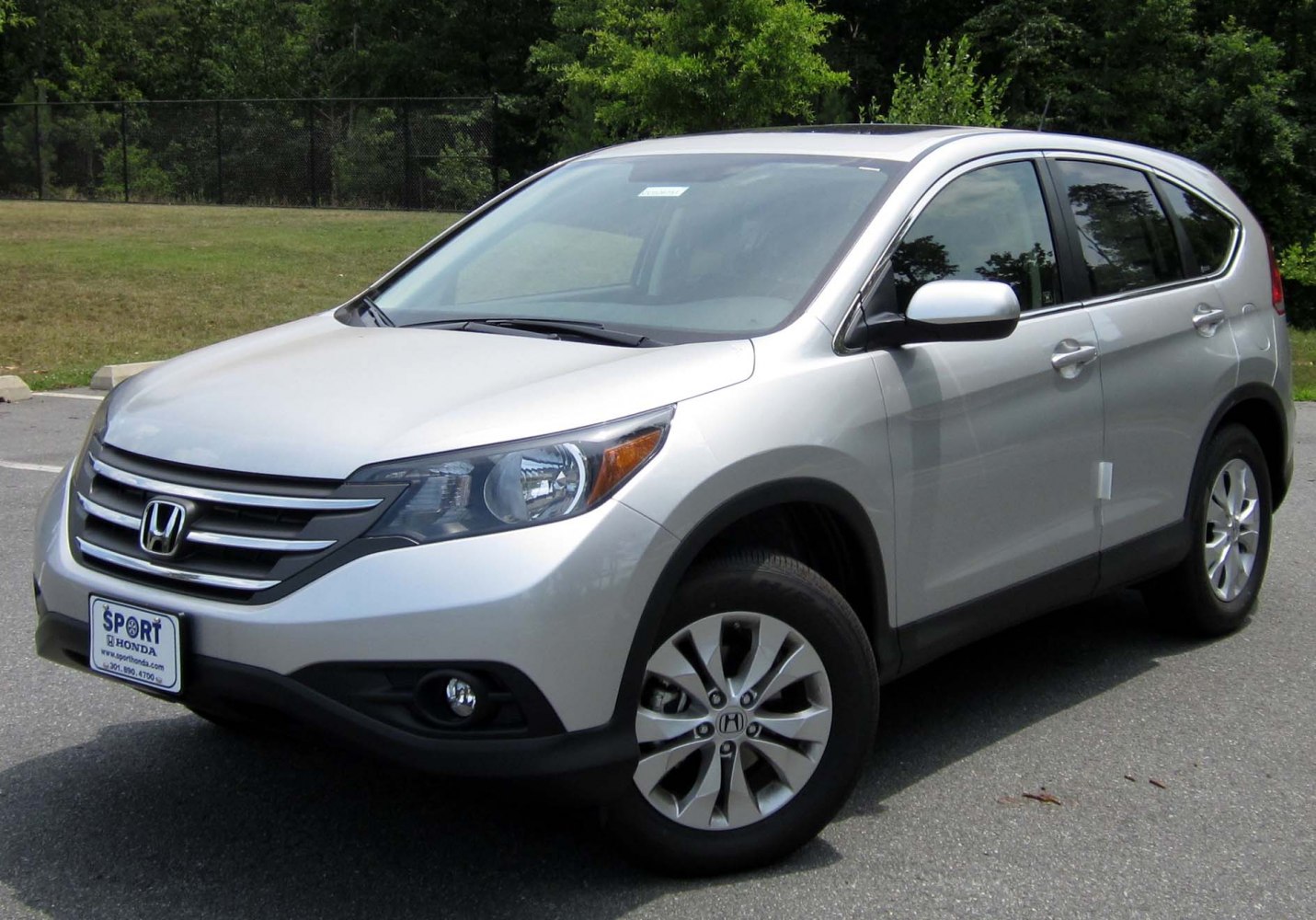 Silver SUV front side view with grille, fog lights, and alloy wheels
