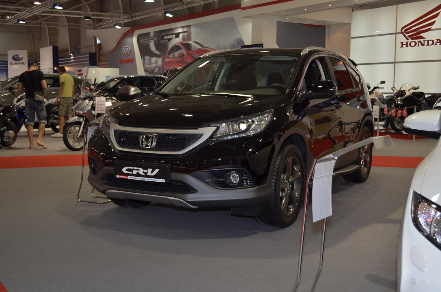 Front view of SUV with headlights and grille at auto show