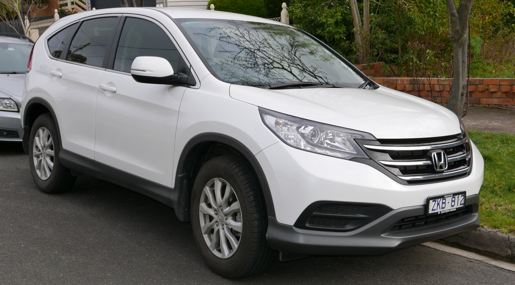 Front-side angle of an SUV showing grille, headlights, and wheel design