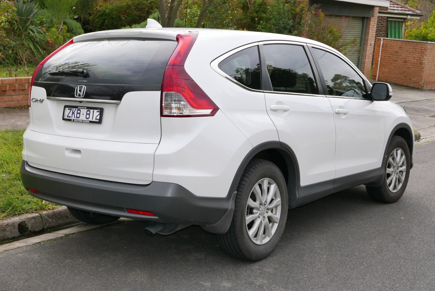 Rear side of white SUV with unique taillights and tinted rear window