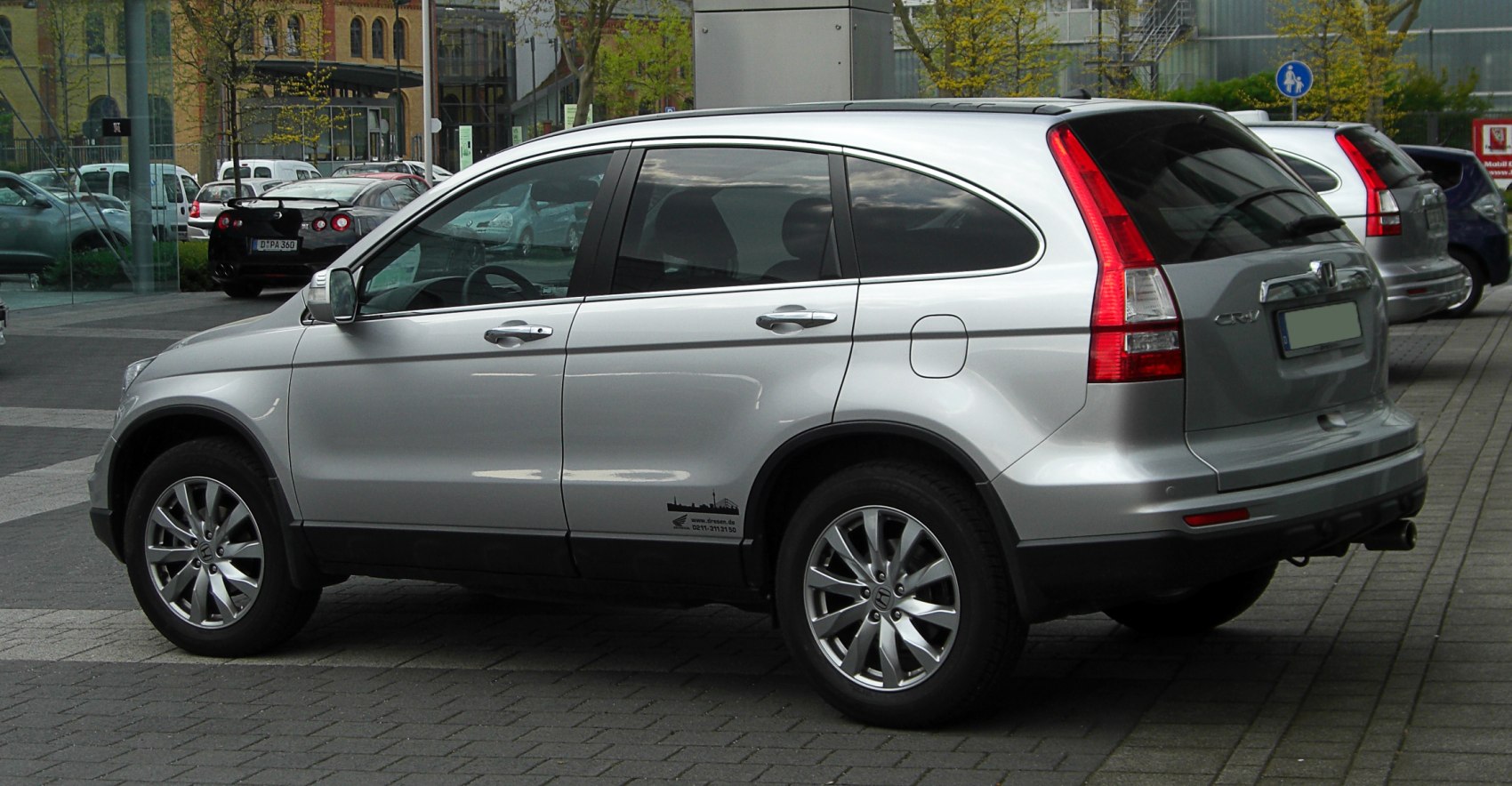 Silver compact SUV side view with tall rear tail lights