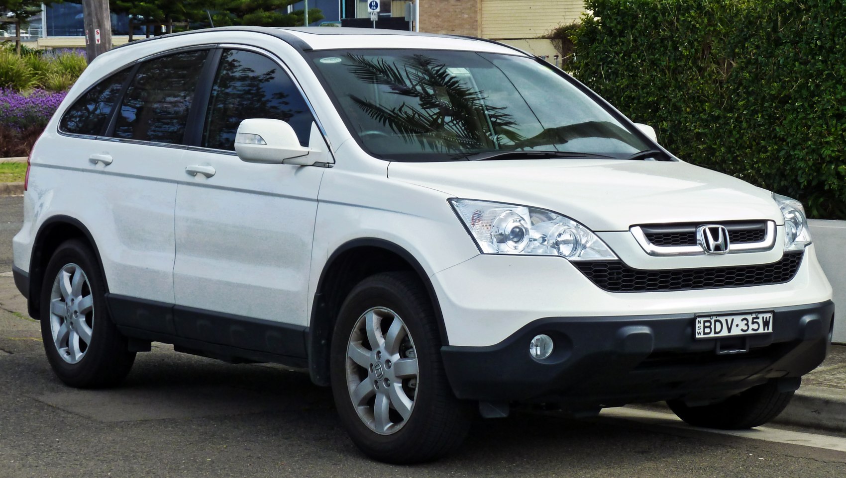 White SUV front side view with alloy wheels and distinct headlights