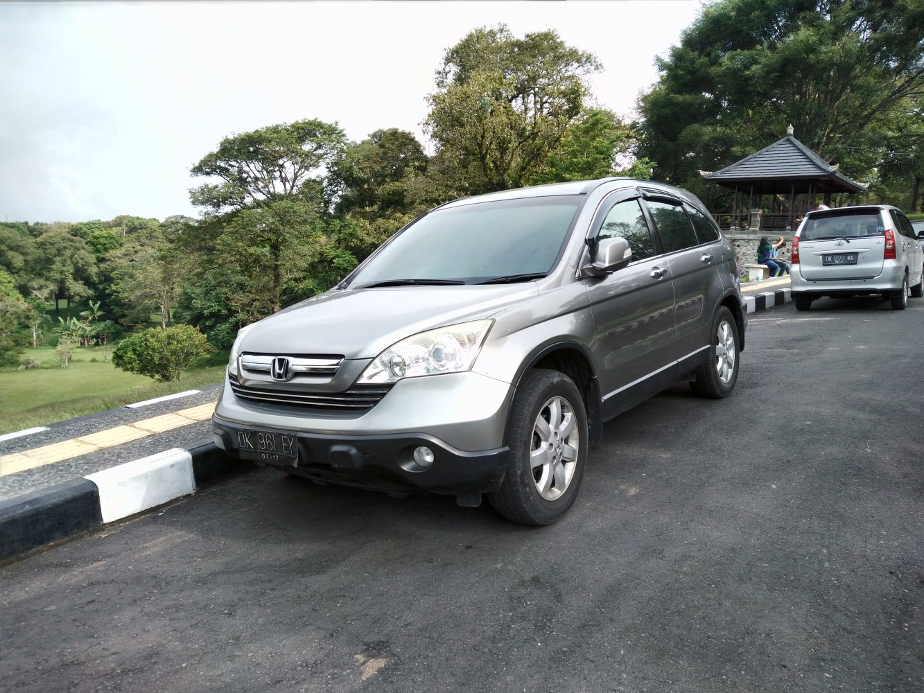 Silver mid-size SUV parked on roadside with front-side view