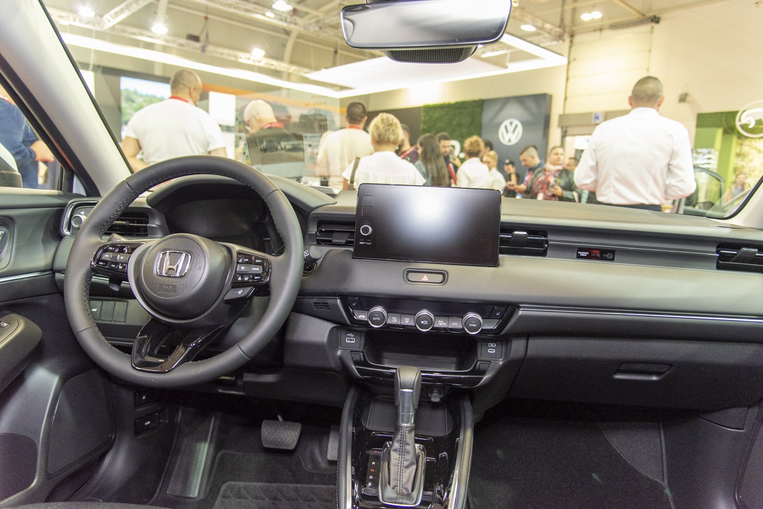 Digital touchscreen display and multifunction steering wheel inside vehicle