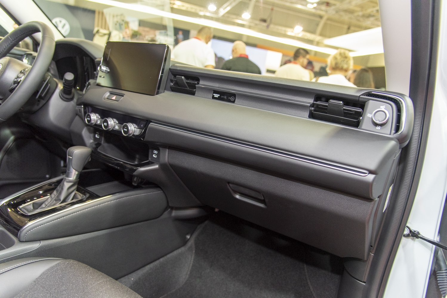 Modern car dashboard with touchscreen and climate control knobs