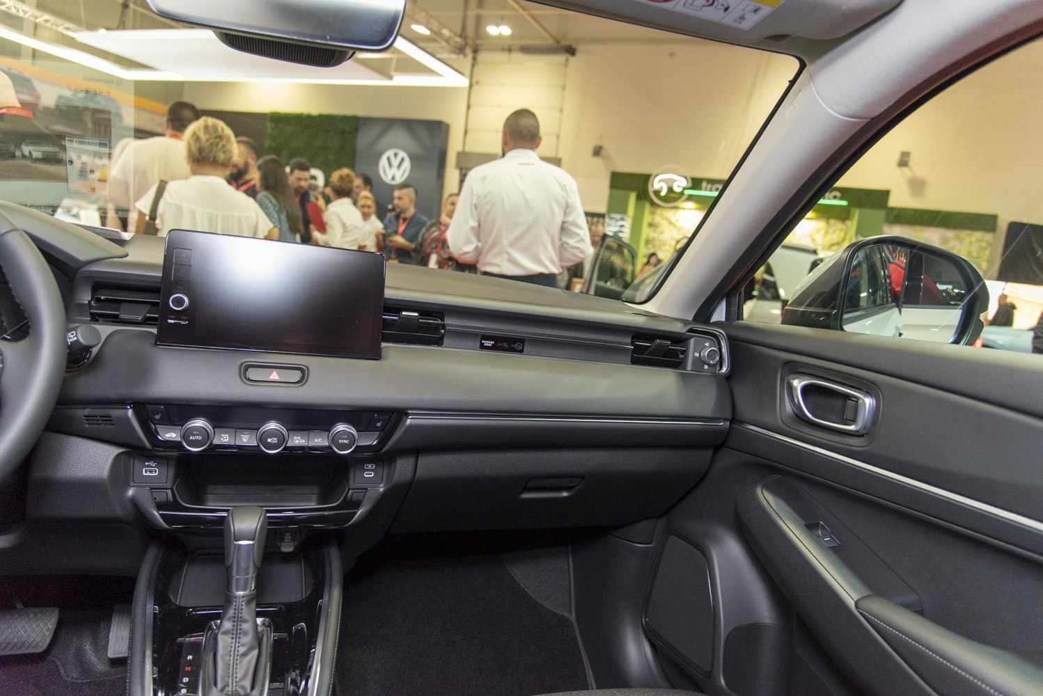 Dashboard with digital display, gear shift, and climate control knobs