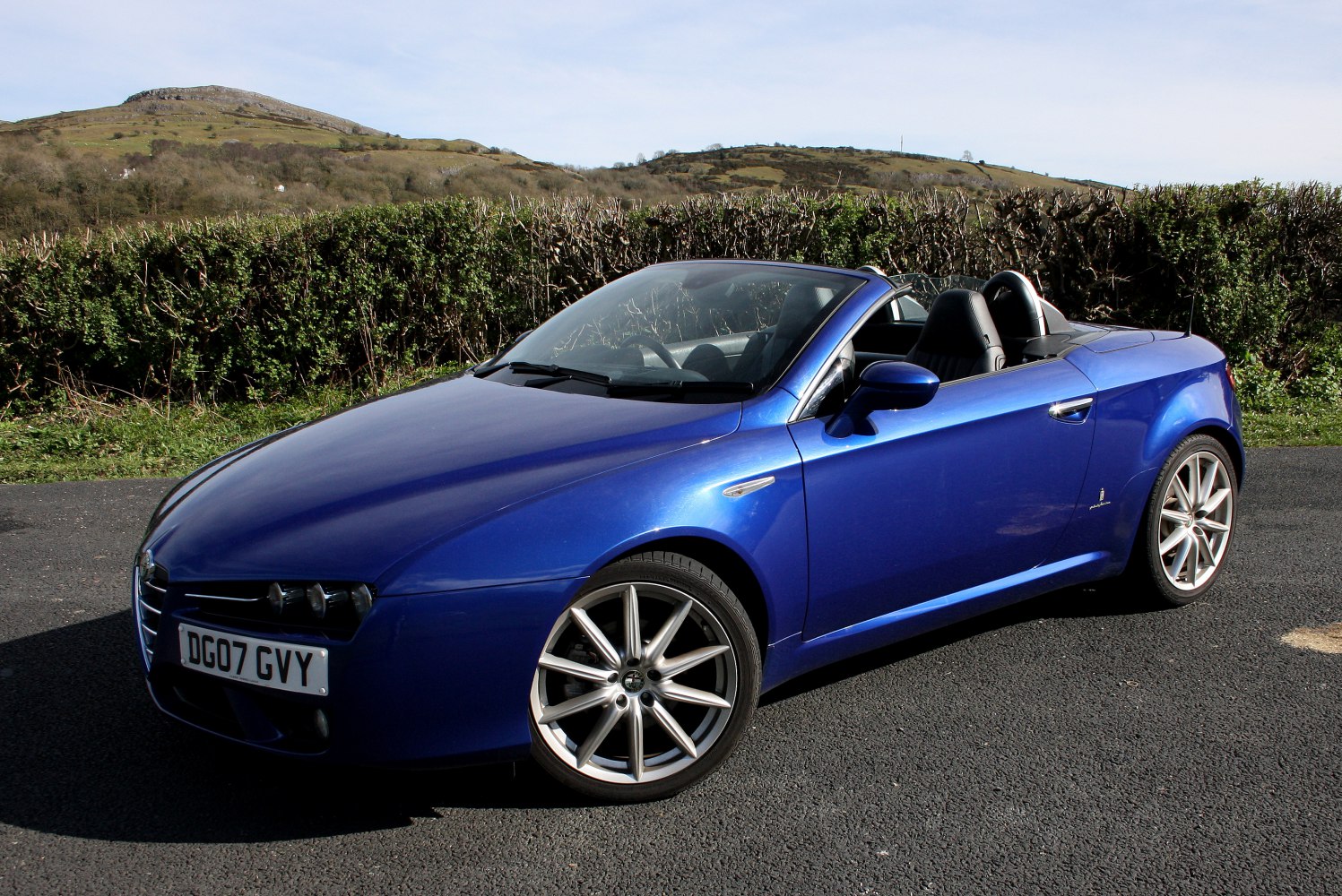Blue convertible roadster with alloy wheels and sporty seats